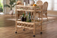 Rattan bar cart with glassware and bottles in bright dining room, FredCo International furniture