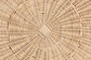 Close-up of round woven rattan furniture detail, natural wicker texture pattern