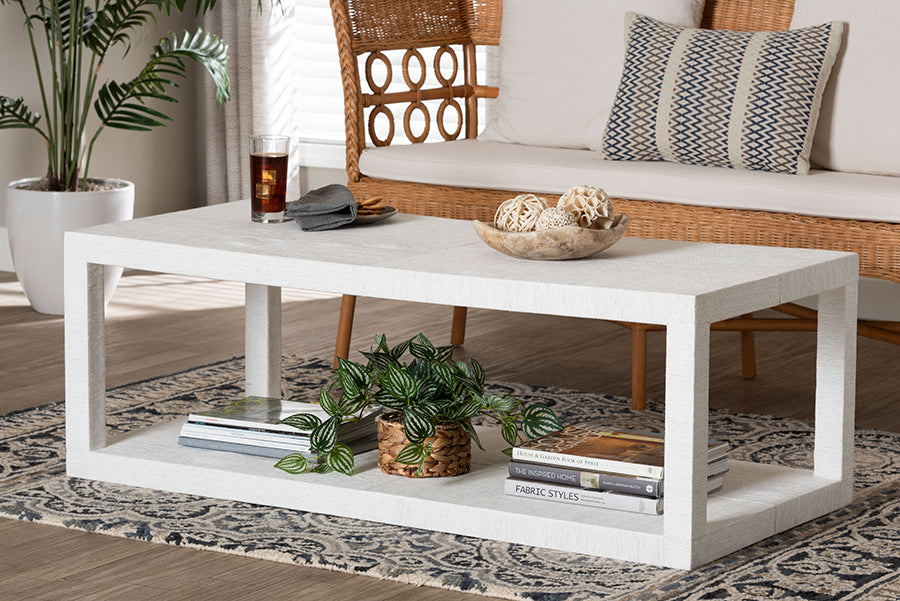 Modern white rectangular coffee table with books, plant, and decor in a stylish living room