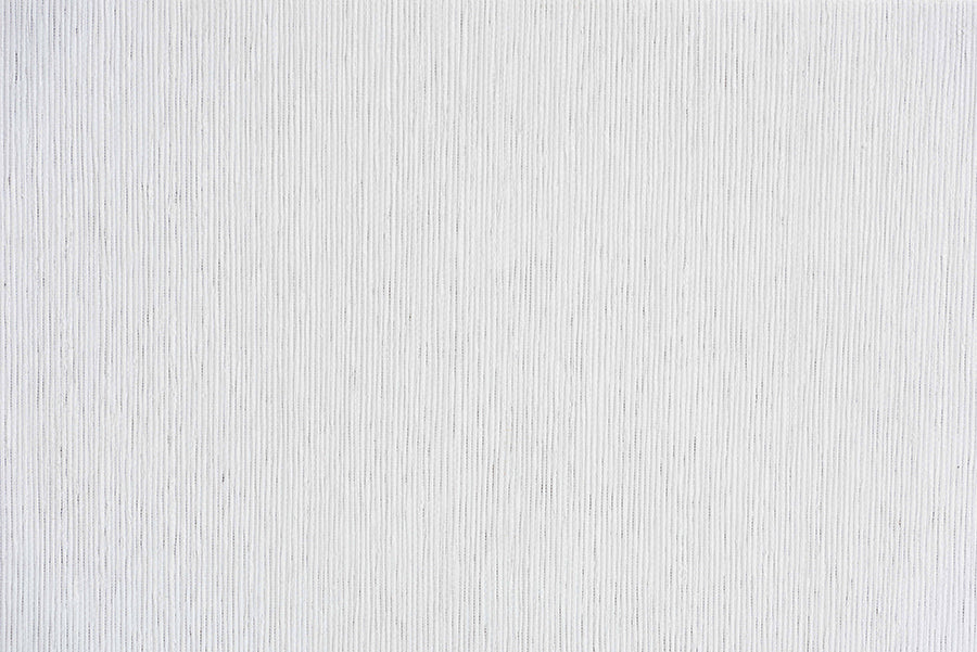 White textured fabric surface with subtle vertical lines, ideal for modern furniture upholstery.