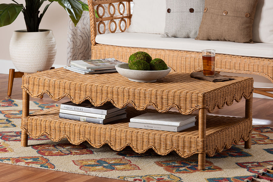 Wicker coffee table with scalloped edges in a cozy living room, styled with books and decor