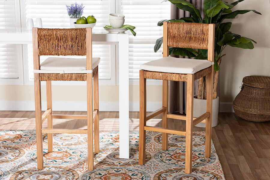Set of two woven rattan counter stools with wood frames and cushions in modern dining room