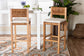 Set of two woven rattan counter stools with wood frames and cushions in modern dining room