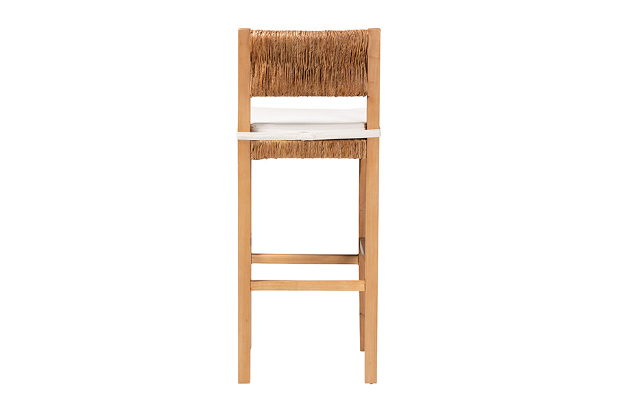Wooden bar stool with woven natural fiber backrest and white cushioned seat