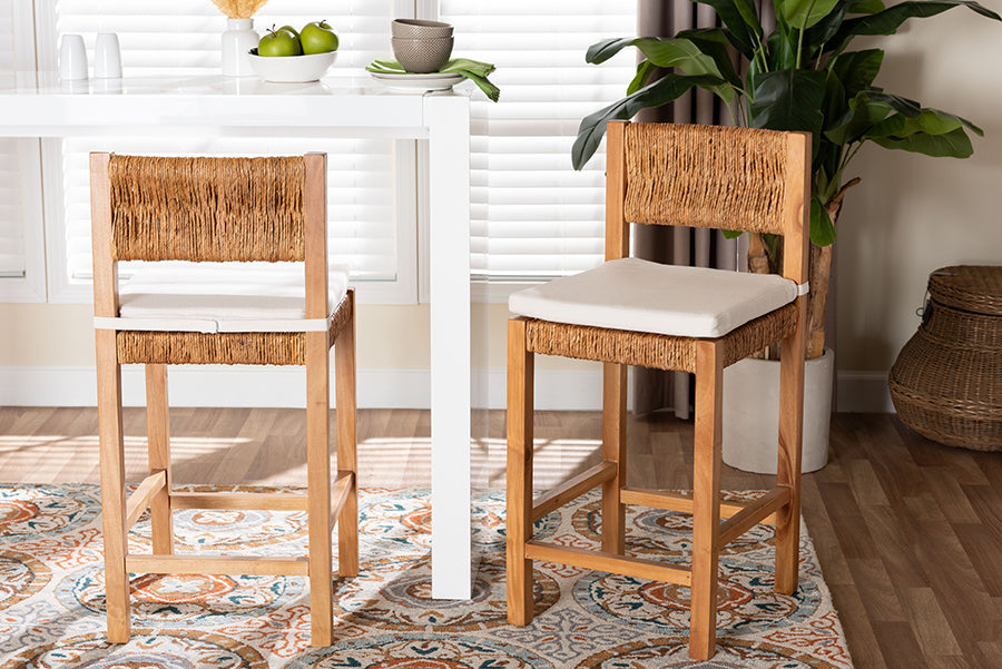 Set of two woven rattan bar stools with cushions at a modern white dining table in a bright room