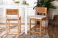 Set of two woven rattan bar stools with cushions at a modern white dining table in a bright room