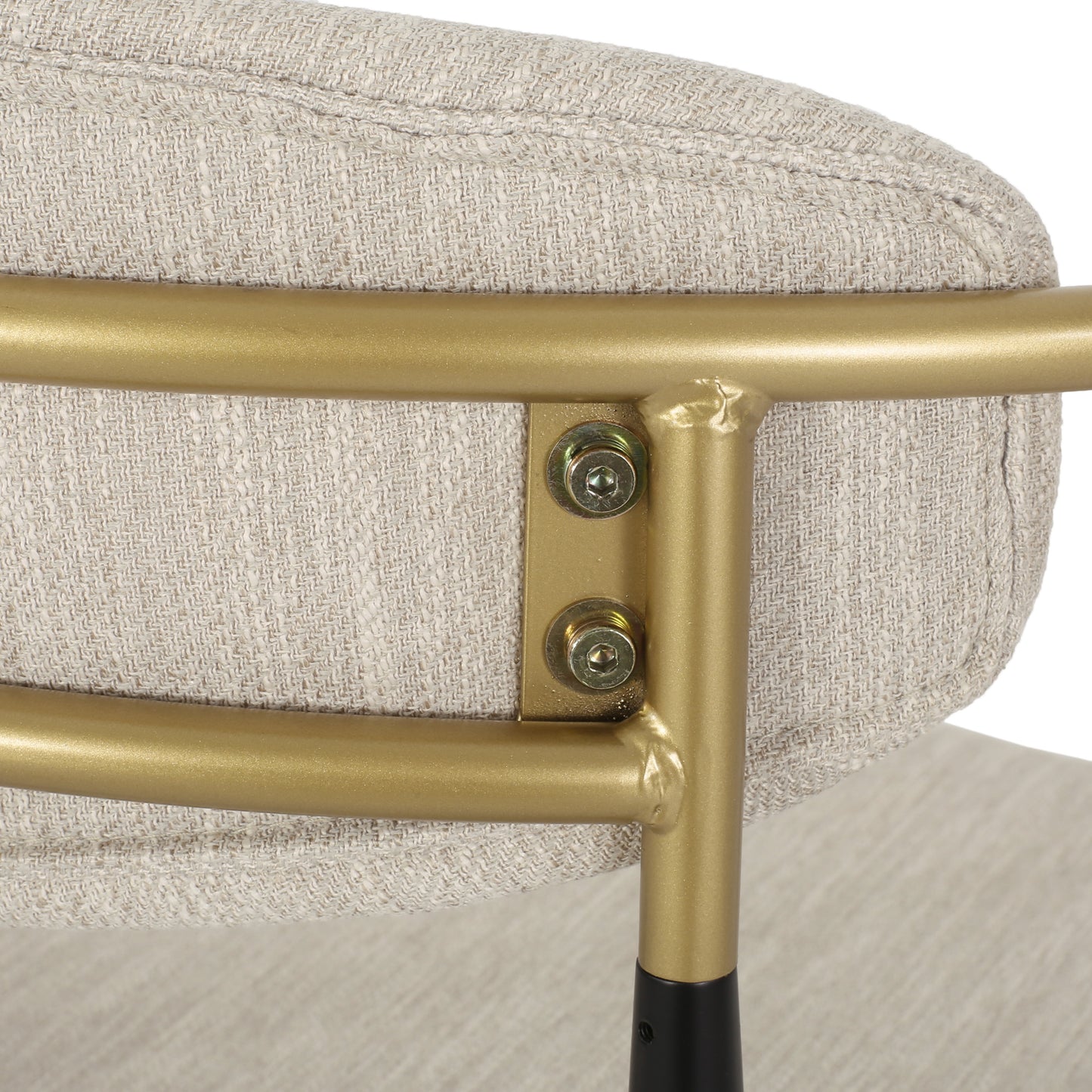Close-up of beige upholstered chair with gold metal frame, FredCo International furniture