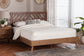 Modern wooden bed with geometric headboard, white bedding, and mid-century nightstand in sunlit bedroom