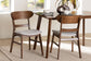 Mid-century modern dining room with two wooden chairs, neutral cushions, and a breakfast table from FredCo International.