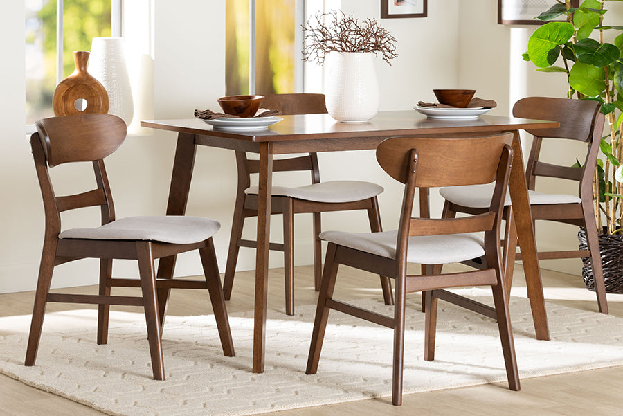 Mid-century modern wood dining set with four chairs in a bright dining room, sold by FredCo International.
