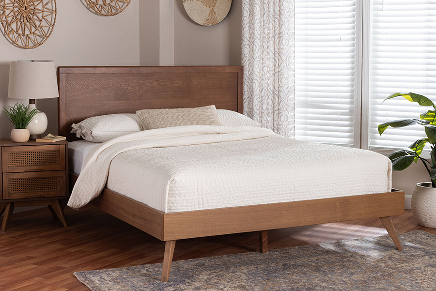Mid-century modern wood bed with white bedding, nightstand, and decor in bright bedroom