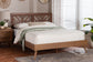 Mid-century modern wooden bed with geometric headboard in a bright bedroom, FredCo furniture
