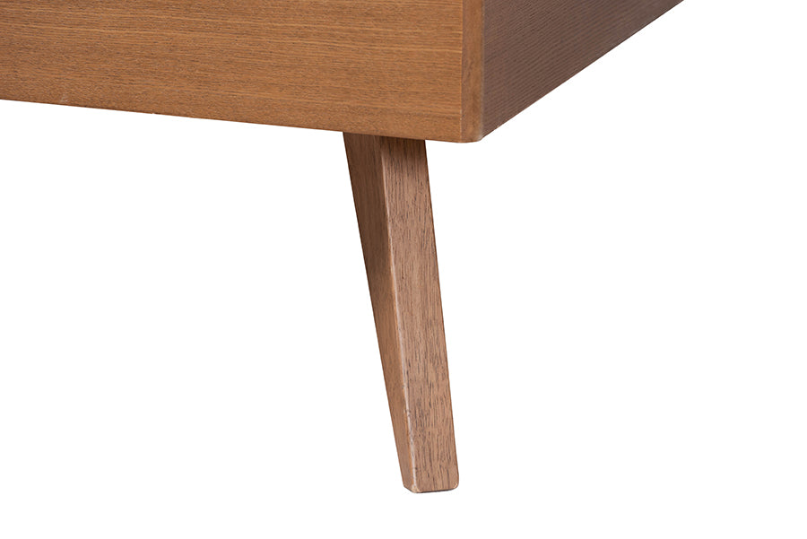 Close-up of a modern wooden furniture leg, mid-century style, from FredCo International
