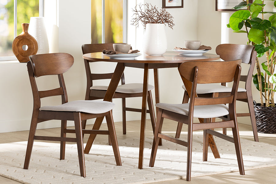 Mid-century modern wood dining set with round table and four chairs in bright dining room