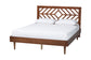 Mid-century modern wooden bed frame with geometric headboard and white bedding