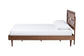 Modern wooden bed frame with geometric headboard and white bedding from FredCo International