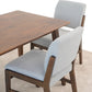 Modern dining set with wooden table and two light gray cushioned chairs on beige rug