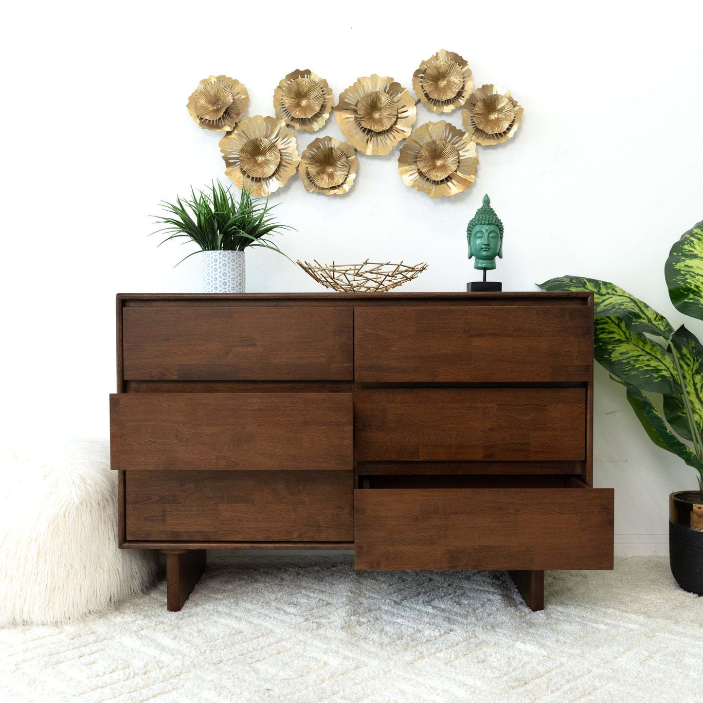 Modern wooden dresser with decor, plants, and gold wall art on a white carpet, FredCo International furniture