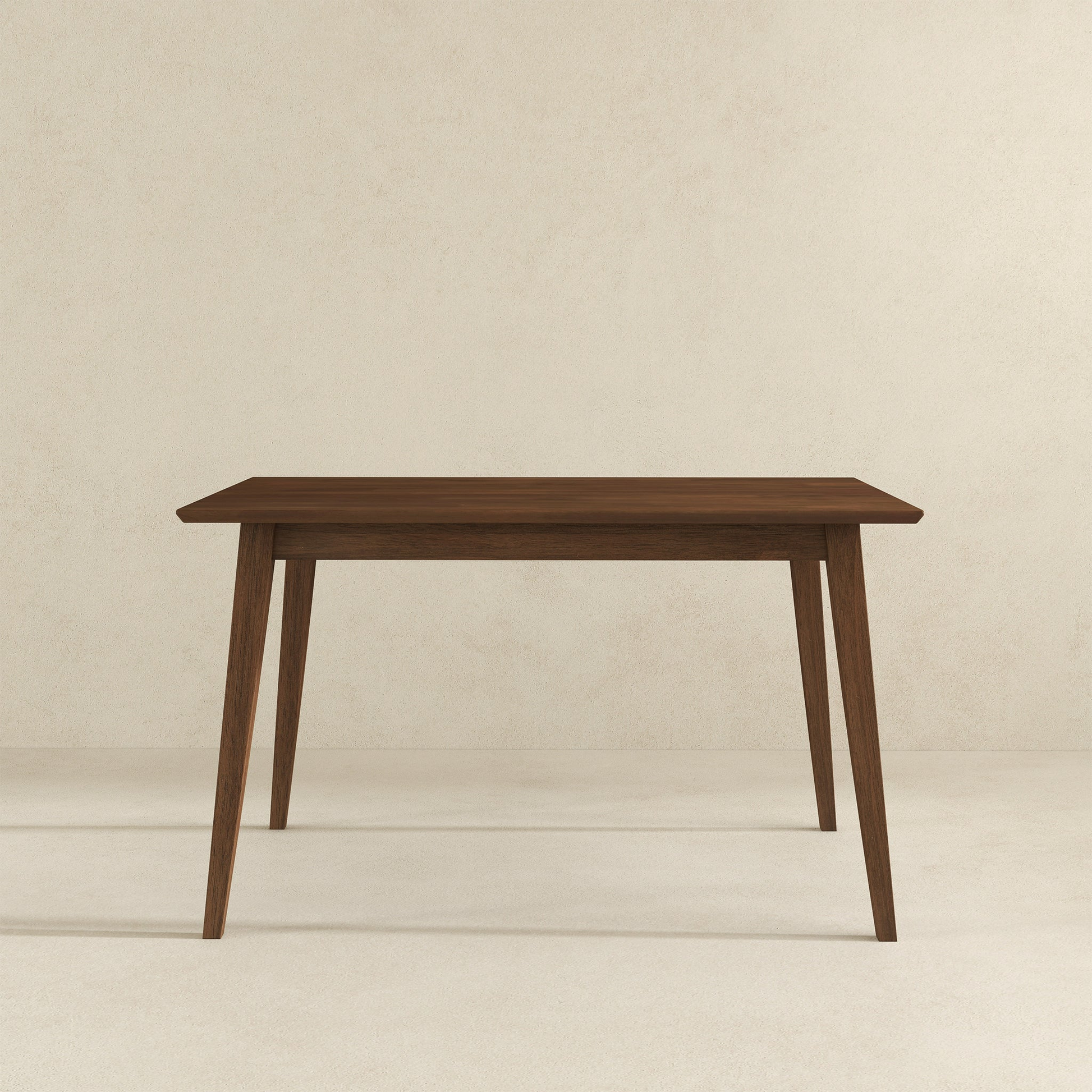 Modern wooden dining table with clean lines on a neutral background, FredCo International furniture