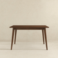Modern wooden dining table with clean lines on a neutral background, FredCo International furniture