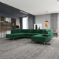 Modern living room with green velvet sectional sofa, gray rug, and open kitchen in stylish home