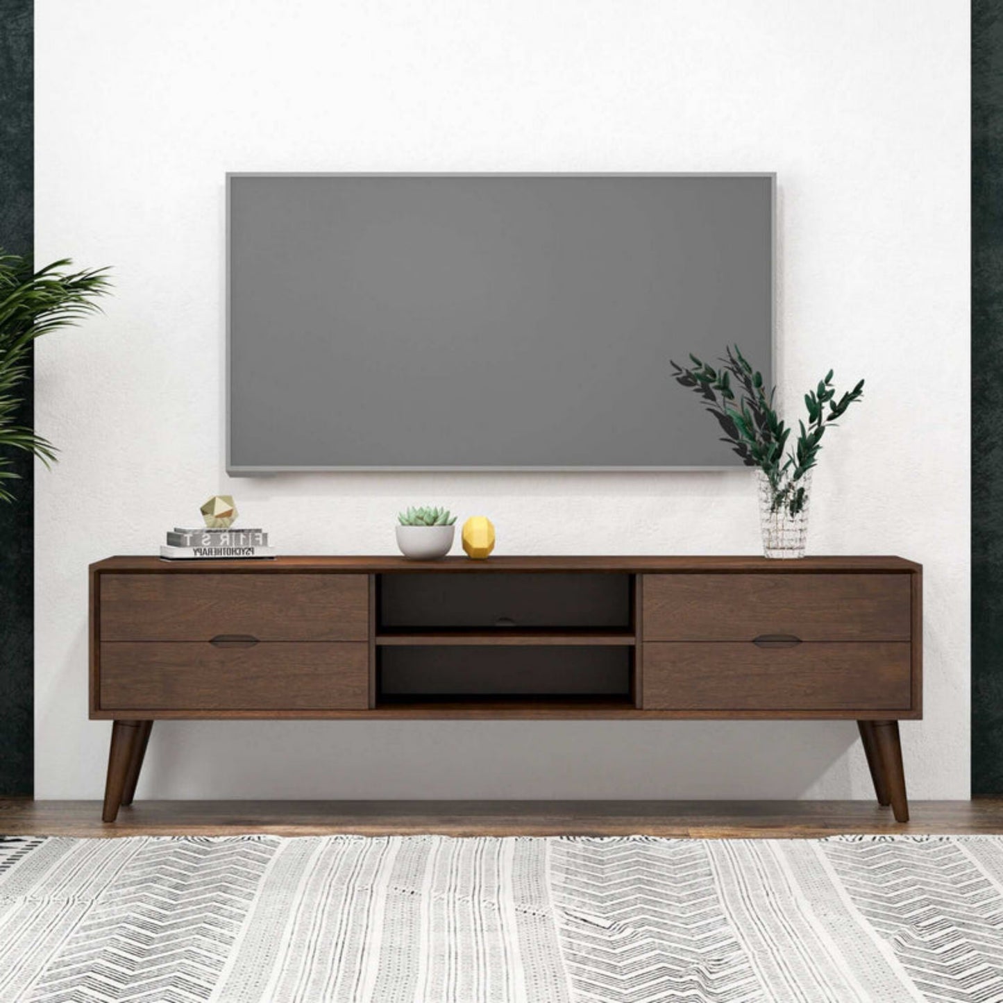 Modern living room with wall-mounted TV, mid-century wood TV stand, and home decor accessories.