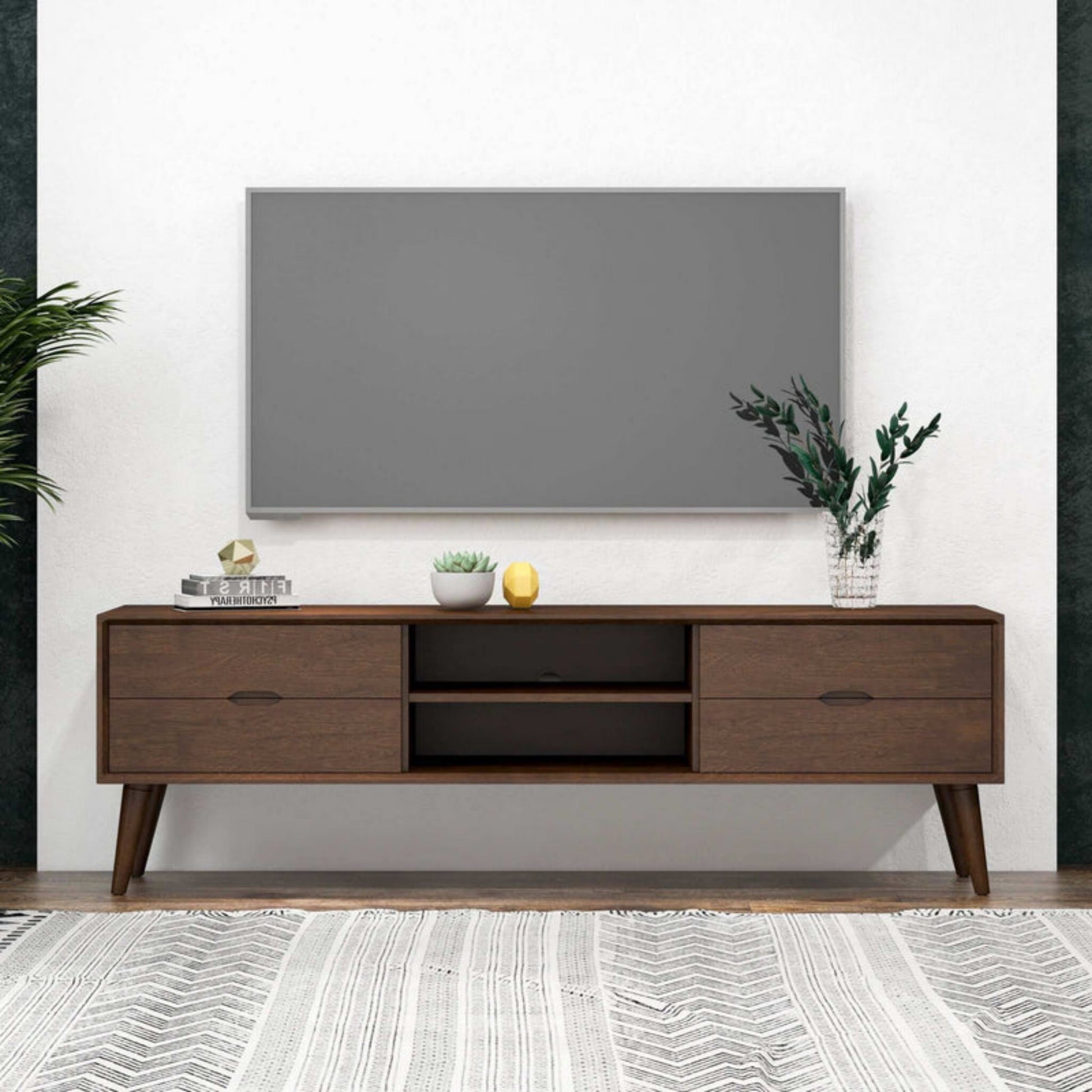 Modern living room with wall-mounted TV, mid-century wood TV stand, and home decor accessories.