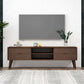 Modern living room with wall-mounted TV, mid-century wood TV stand, and home decor accessories.