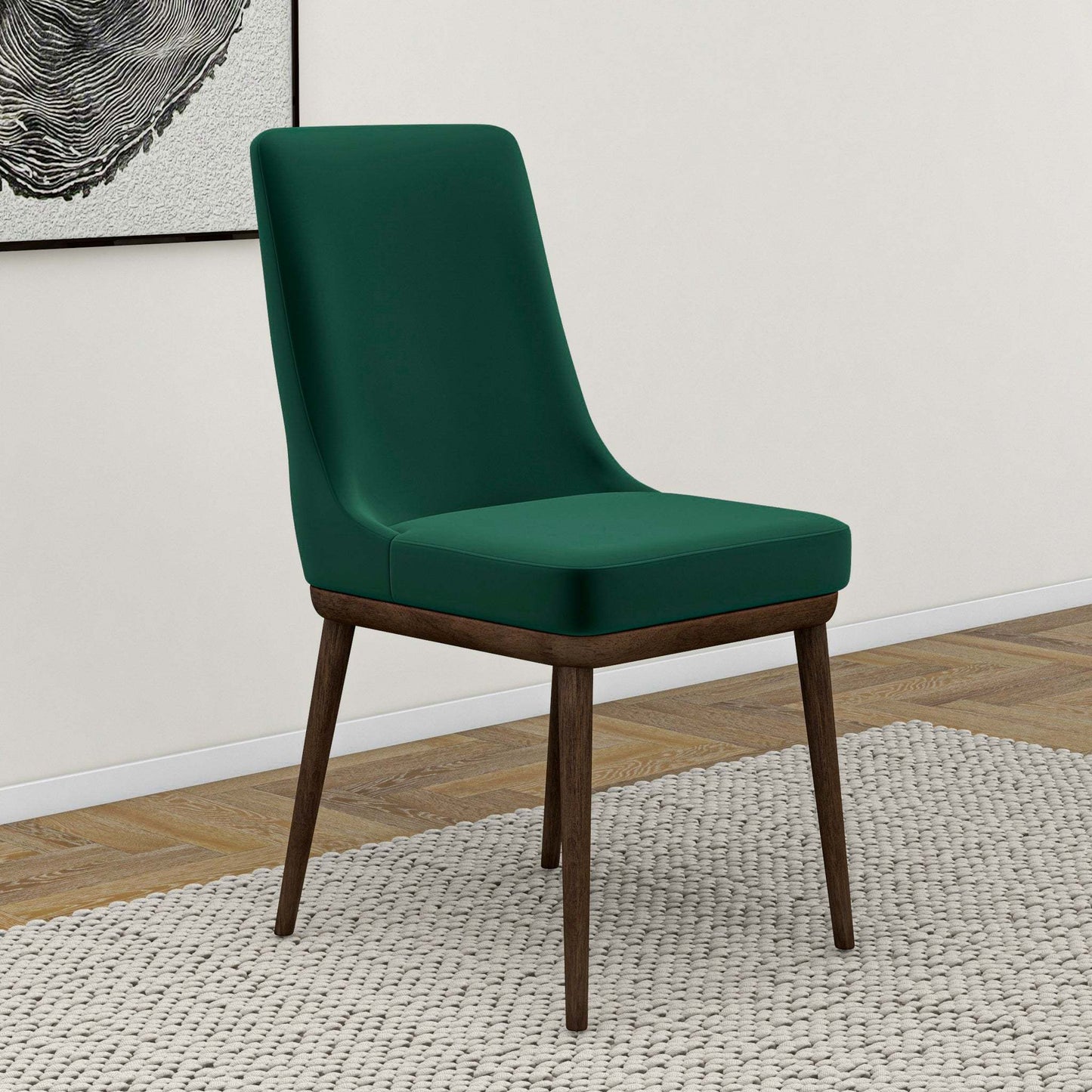 Green upholstered dining chair with dark wooden legs on a rug in modern home setting
