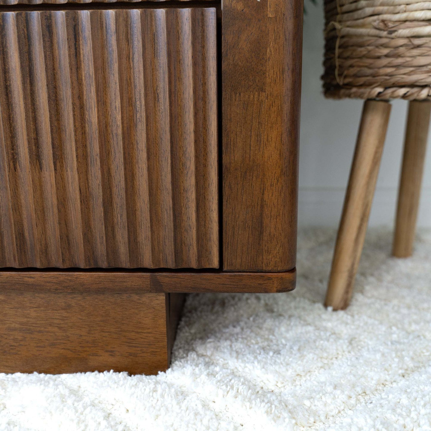 Mid-century modern wooden furniture on plush rug, textured cabinet, home decor at FredCo International