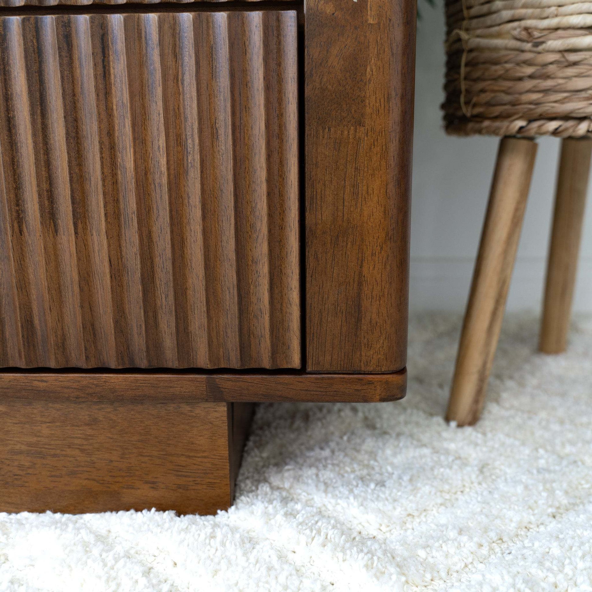 Mid-century modern wooden furniture on plush rug, textured cabinet, home decor at FredCo International