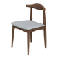 Modern wooden dining chair with light gray cushion, available at FredCo International