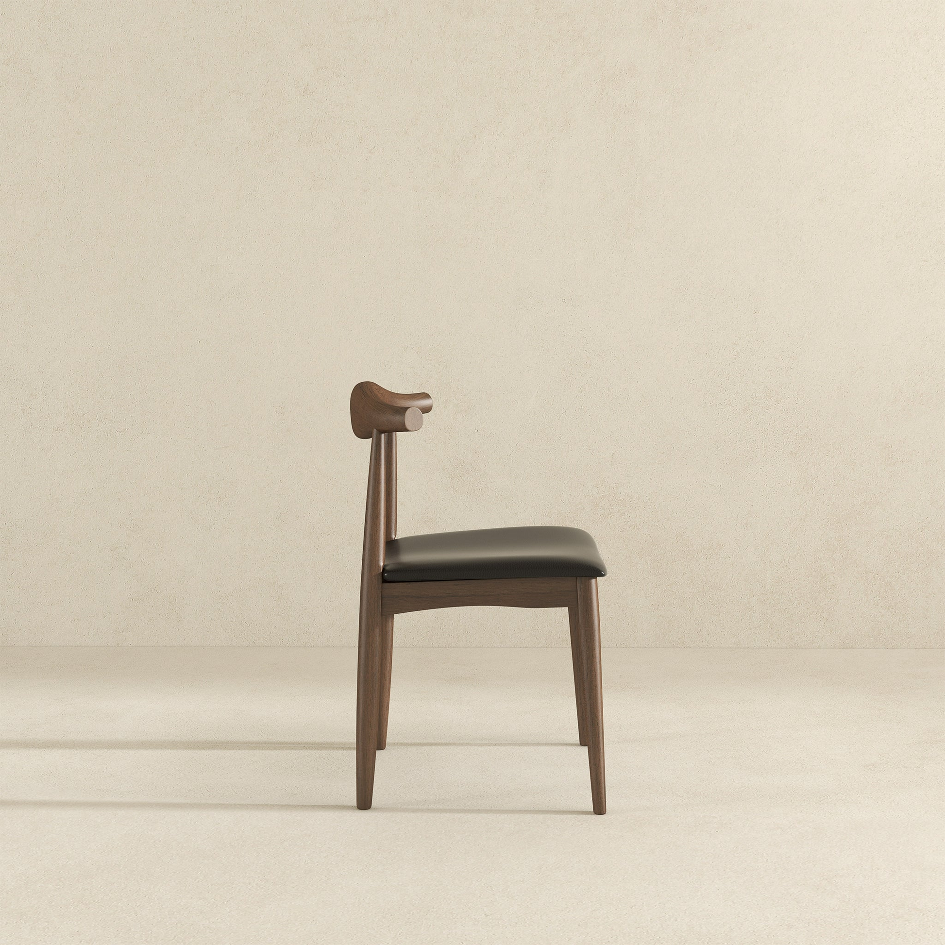 Modern wood dining chair with black cushion on neutral background, FredCo International furniture