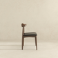 Modern wood dining chair with black cushion on neutral background, FredCo International furniture