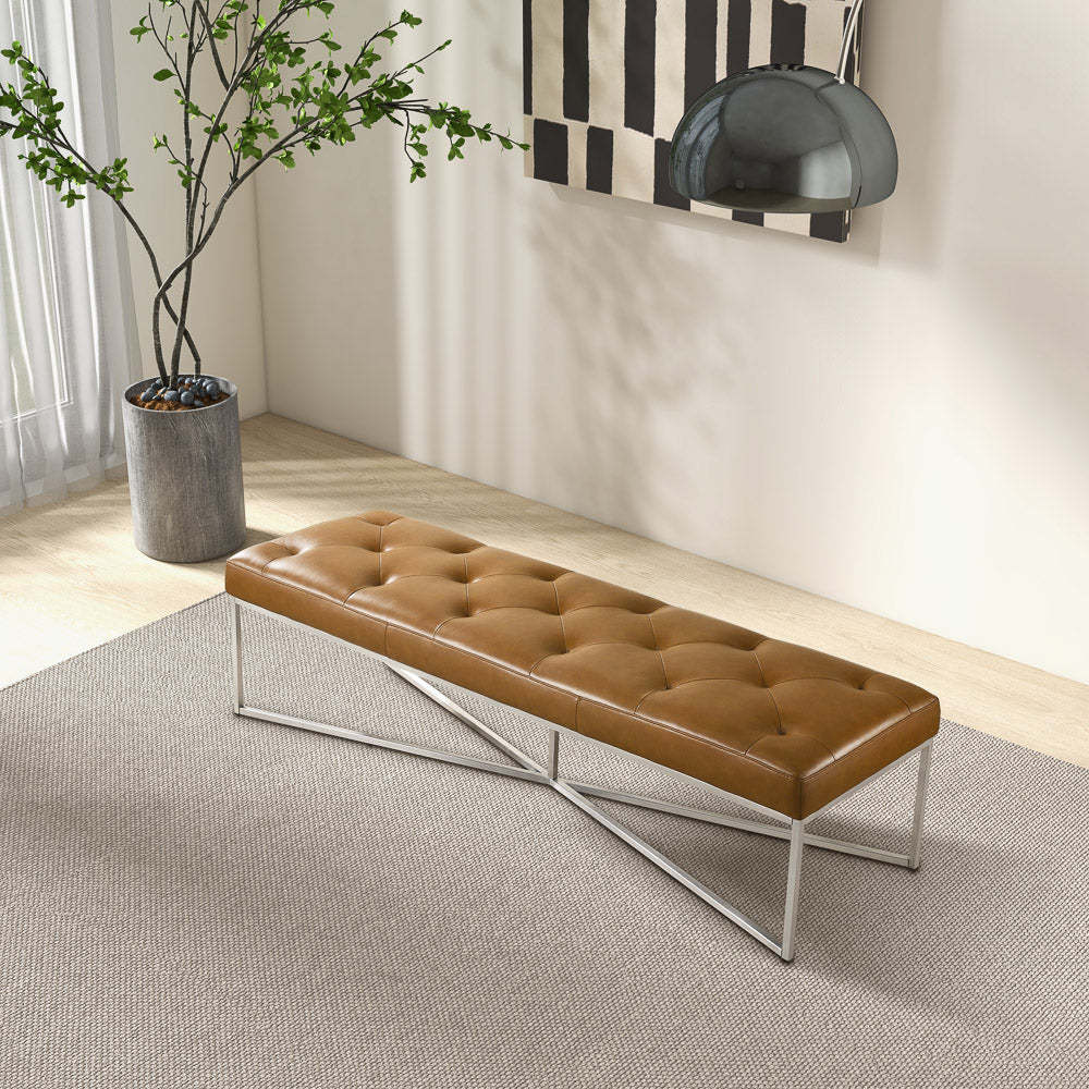 Modern brown tufted bench with metal legs on a grey rug in a bright living room setting