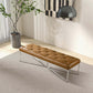 Modern brown tufted bench with metal legs on a grey rug in a bright living room setting