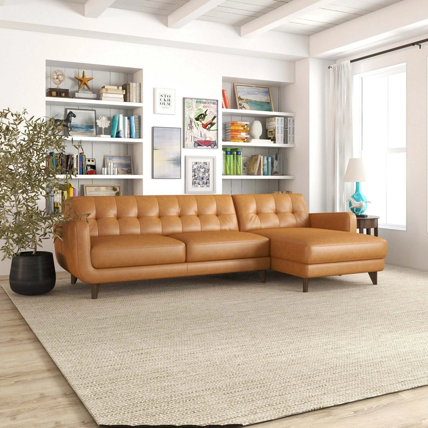 Mid-century tan leather sectional sofa in modern living room with bookshelves, lamp, and art.