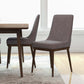 Modern gray dining chairs with wood legs next to dining table in bright home interior