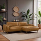 Modern tan leather sectional sofa in stylish living room with houseplants and neutral decor
