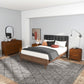 Mid-century modern bedroom with wood bed, dresser, nightstands, grey tufted headboard and decor.