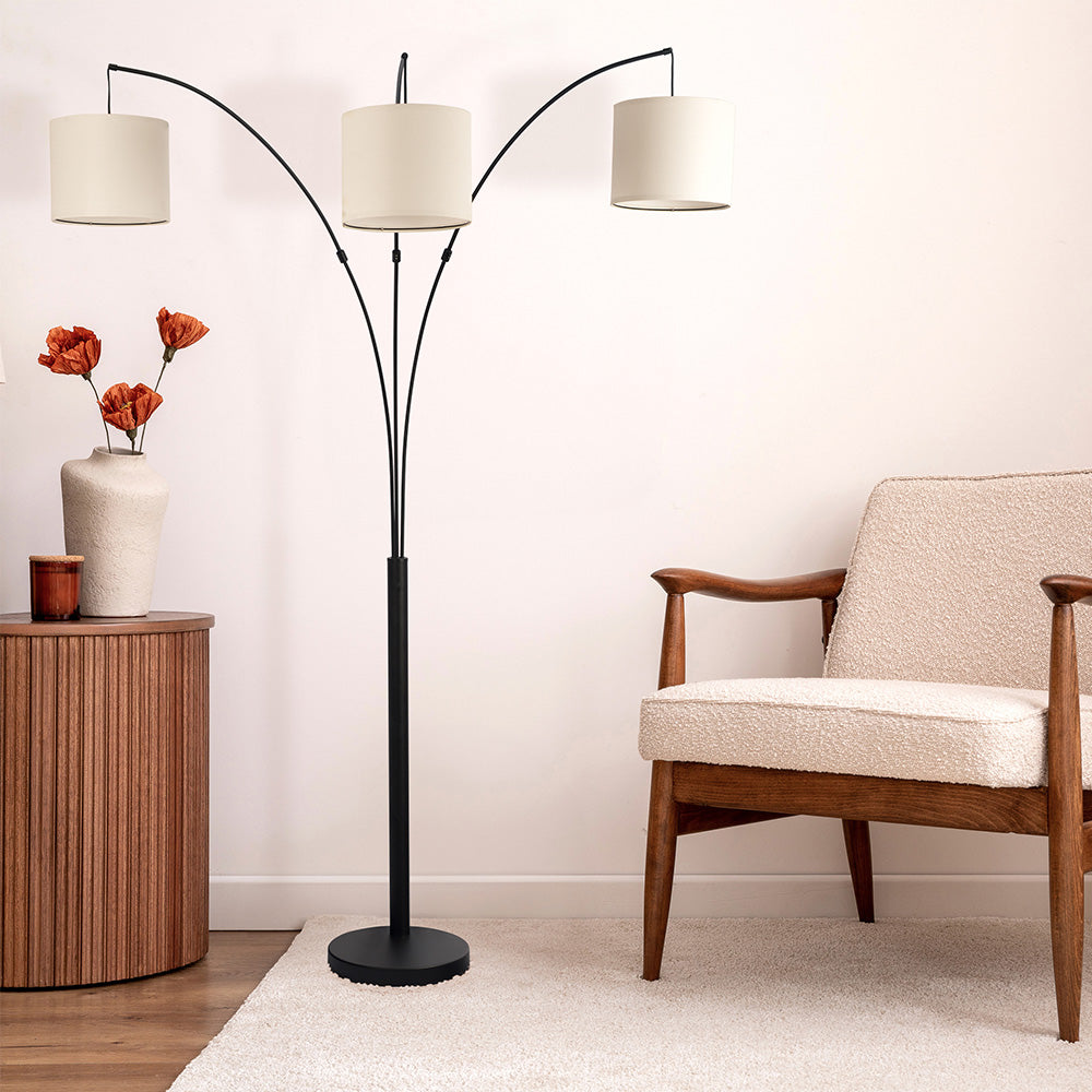 Modern living room with triple floor lamp, armchair, and wood accent table from FredCo International
