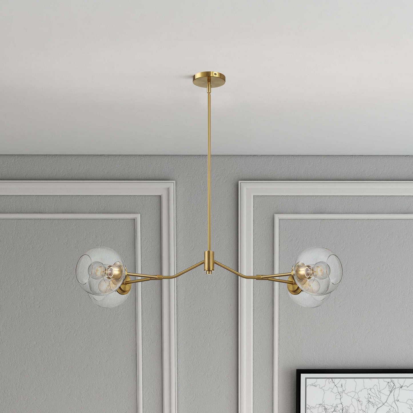 Modern gold chandelier with glass globes in a gray paneled room, FredCo International
