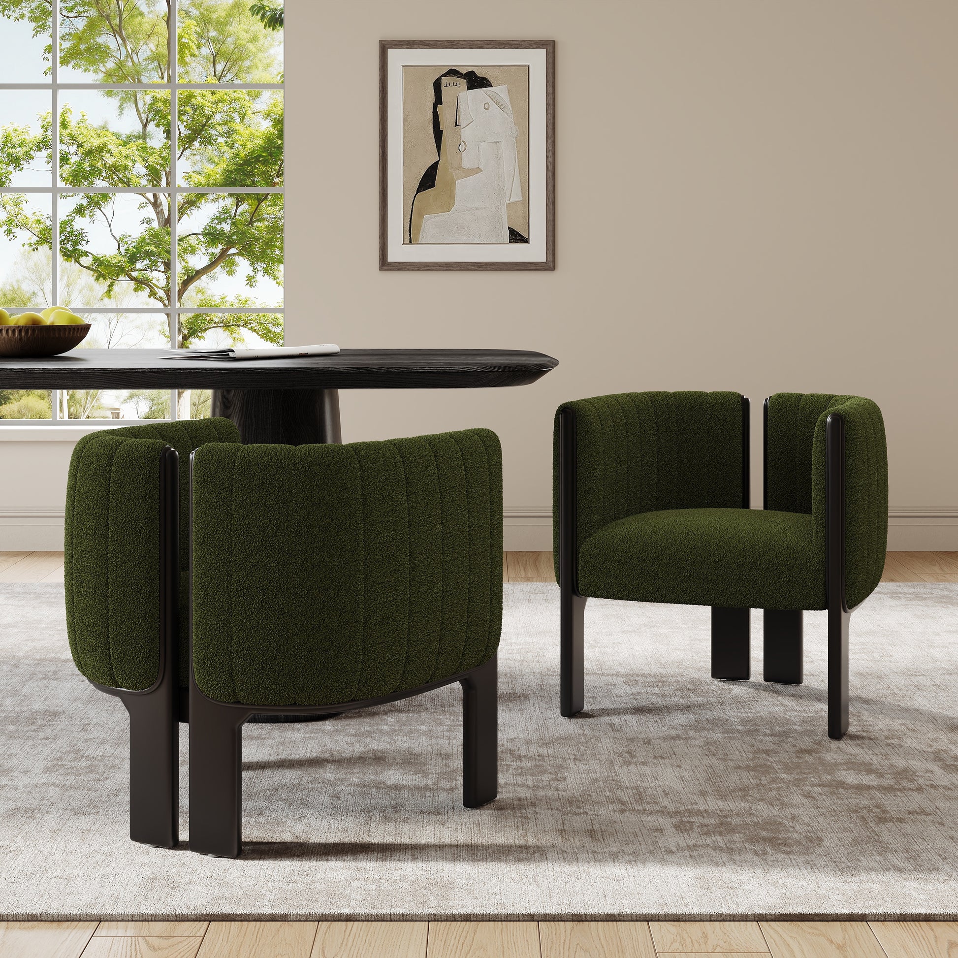 Modern dining room with green armchairs, round table, large window, and abstract wall art