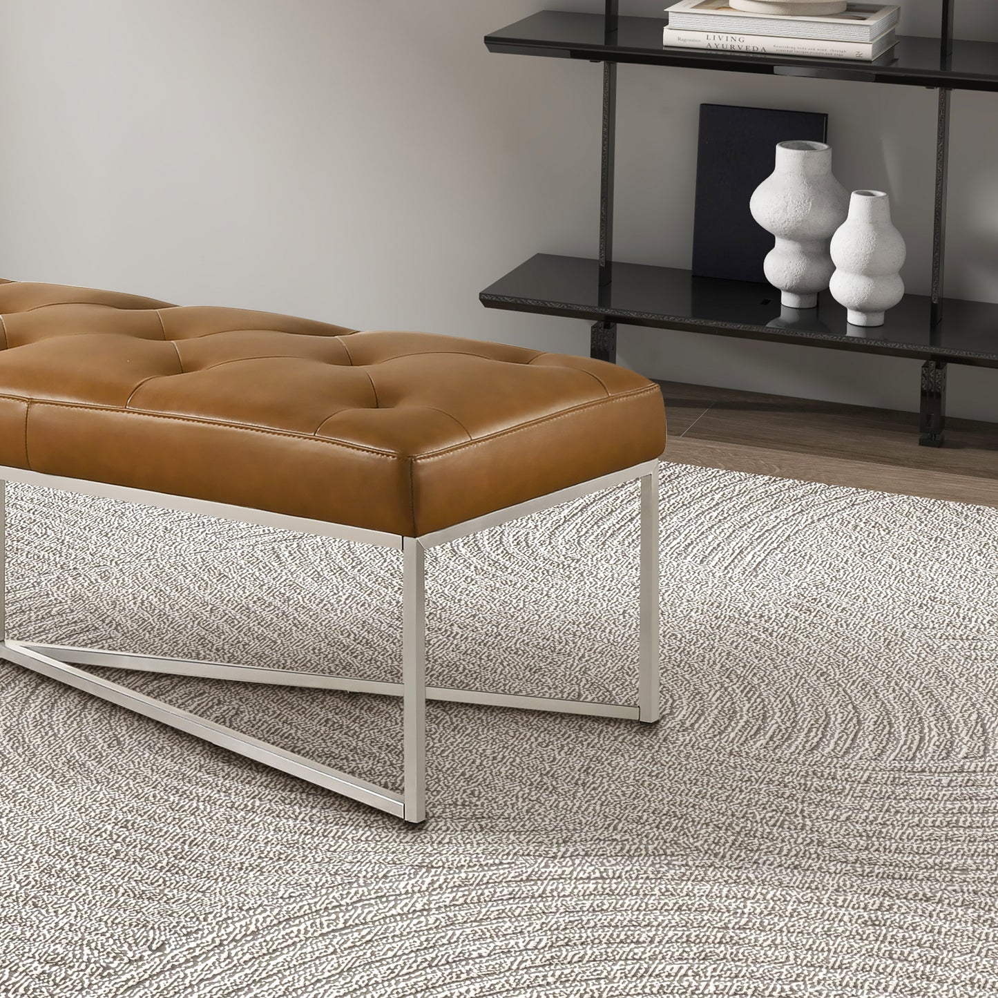 Modern brown leather bench with metal legs on textured rug in stylish home interior