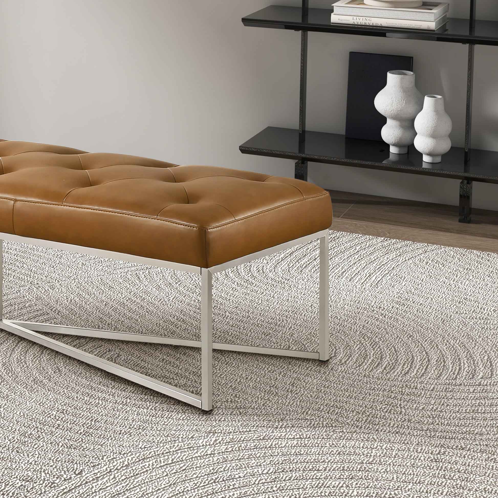 Modern brown leather bench with metal legs on textured rug in stylish home interior