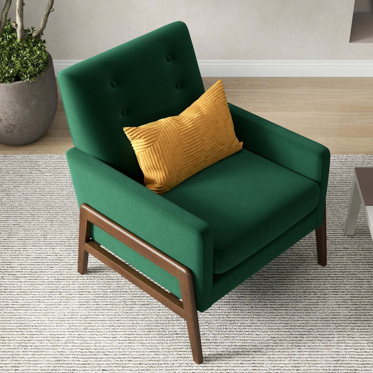 Modern green accent chair with wooden legs and yellow pillow in stylish living room setting