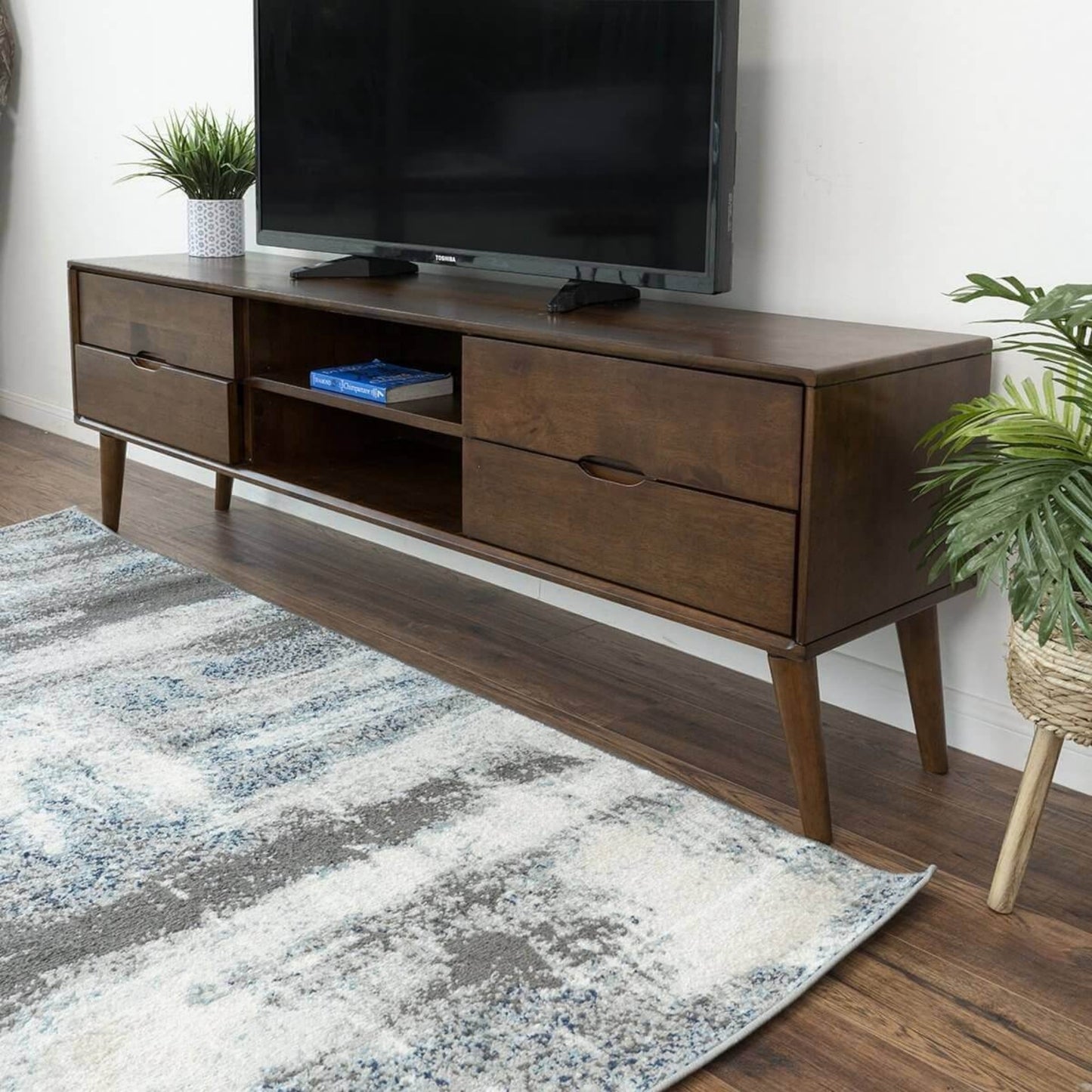 Mid-century modern wooden TV stand with storage drawers in a living room, FredCo International furniture