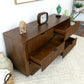 Modern wood dresser with open drawers, decor accents, and home furniture on white rug