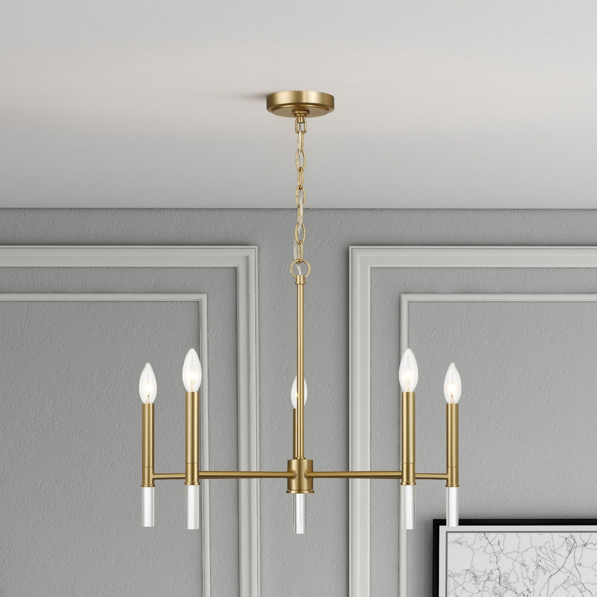 Modern gold chandelier with six candle lights in a stylish gray living room