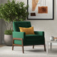 Green accent chair with yellow pillow in modern living room, potted plant, abstract wall art, FredCo International furniture